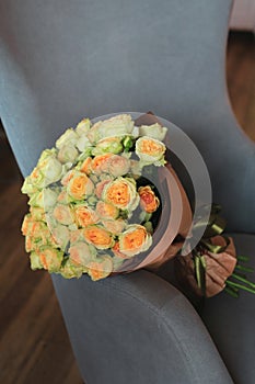 Yellow english roses Pat Austin bouquet on a armchair