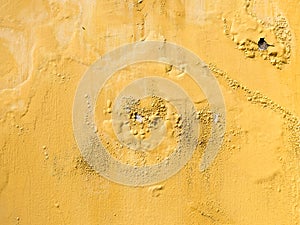 yellow erode painted concrete wall,grunge rough texture background