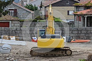 Yellow excavator at construction site