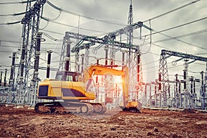 Yellow excavator at construction site of power plant. Excavator bucket on excavated ground