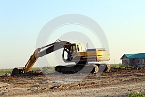 Yellow excavator excavating