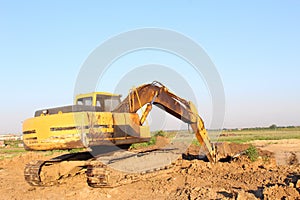 Yellow excavator excavating