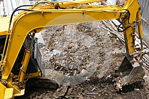 yellow excavator hydraulic engine or macro truck working in house construction site separate garbage on soil