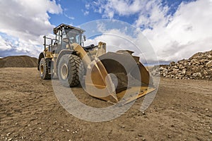 Yellow excavator moving earth at a construction site