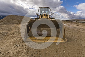 Yellow excavator moving earth at a construction site