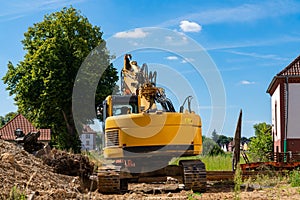 Yellow excavator outdoors at a construction site