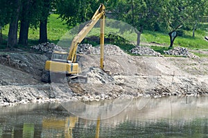 Yellow Excavator at Riverbank