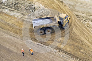 Yellow excavator at a road construction site