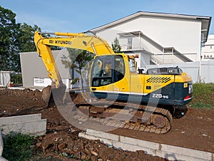 Yellow Excavator on Construction Site for Earthmoving and Groundwork.