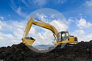 Yellow excavators are digging the soil in the construction site