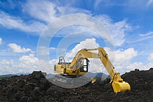 Yellow excavators are digging the soil in the construction site