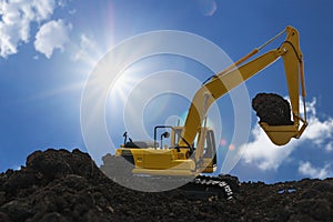 Yellow excavators are digging the soil in construction site