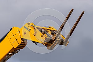 Yellow extendable arm forklift truck