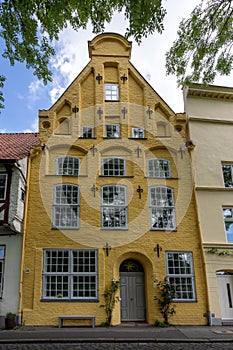 Yellow facade of an historic old town house in the centre of the hanseatic city Luebeck, Germany