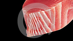 Yellow fin tuna steak isolated on black background. Fresh rare tuna steak isolated on black. Raw yellowfin tuna fillet texture.