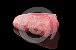 Yellow fin tuna steak isolated on black background. Fresh rare tuna steak isolated. Raw yellowfin tuna fillet texture. Background