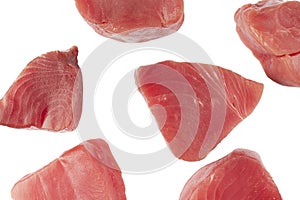 Yellow fin tuna steaks isolated on black background. Fresh rare tuna steaks isolated on black. Raw yellowfin tuna fillet texture.