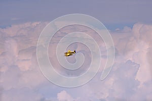 Yellow firefighting aircraft in the clouds