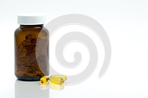 Yellow fish oil capsule pills with amber glass bottle