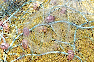 Yellow fishing net drying on the shore. Close up view.