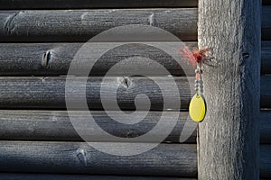 yellow fishing tackle haning on a weathered grey fence photo