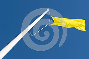 Yellow Flag and Blue Sky