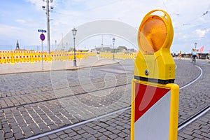 Yellow flashing light standing at road construction site. Road works concept.