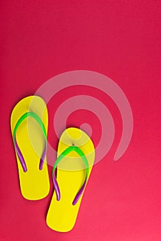 Yellow flip flop on red background