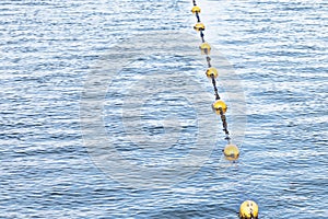 Yellow float floats on a rope floating in the sea