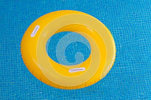 Yellow float on a pool with crystal clear water