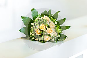 Yellow flower bouquet on white handle bar