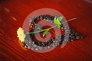 flower on a heart shaped cofee beans