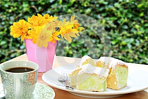 Yellow flower on the wooden table and sweet butter bread of dish