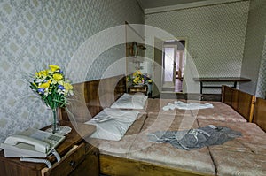 yellow flowers near a bed in hotel room