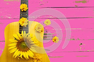 yellow flowers sunflowers, cosmos on guitar arrangement flat lay style