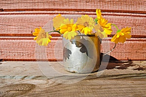 Yellow flowers on the unpainted wooden surface