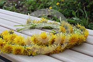 Yellow flowers in a wreath on a wooden background