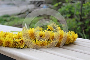 Yellow flowers in a wreath on a wooden background