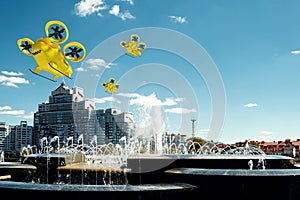 Yellow flying taxi against the sky, city electric transport drone. Car with propellers, clean air, fast ride. Mixed media, copy