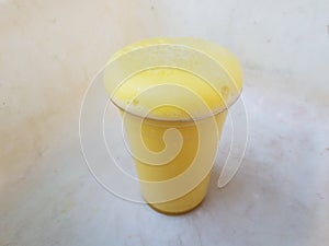 Yellow foam science experiment overflowing cup in plastic container