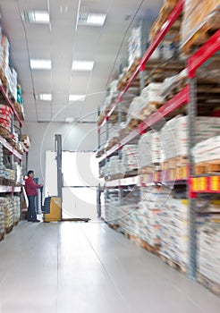 Yellow fork lifter work in big warehouse