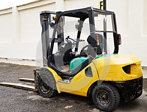 Yellow Forklift stands on a construction site photo