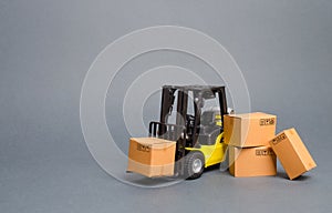Yellow Forklift truck with cardboard boxes. Increase sales, production of goods. transportation, storage of cargo and goods