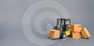Yellow Forklift truck with cardboard boxes. Increase sales, production of goods. transportation, storage of cargo and goods