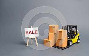 Yellow Forklift truck with cardboard boxes and stand with the word sale. sale of goods, big discounts on goods of the outgoing