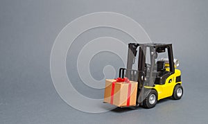 Yellow forklift truck carries a gift with a red bow. Purchase and delivery of a present. retail, discounts and contests