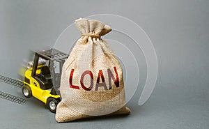 Yellow forklift truck crashed into the bag with the word loan and can not lift it. Inability to repay a loan, debt restructuring