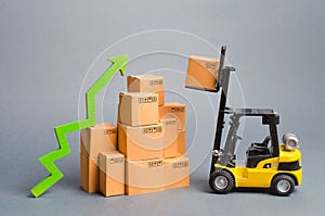 Yellow Forklift truckraises a box over a stack of boxes and a green arrow up. High trade volumes, increased production, storage