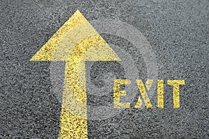 Yellow forward road sign with Exit word on the asphalt road.