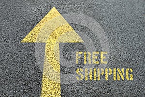 Yellow forward road sign with Free Shipping word on the asphalt